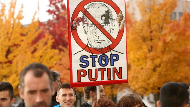 Activists demonstrate against Russian military operations in Syria during a visit by Russian President Vladimir Putin to the German federal Chancellery on Wednesday.