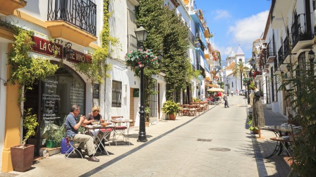 A side street in Marbella Old Town with bars and restaurants.