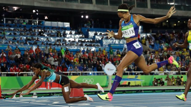 Shaunae Miller falls over the finish line to win gold ahead of Allyson Felix in the women's 400-metre final.
