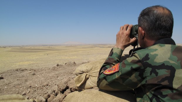 Peshmerga soldier looks over no-mans-land towards ISIL controlled areas of northern Iraq.