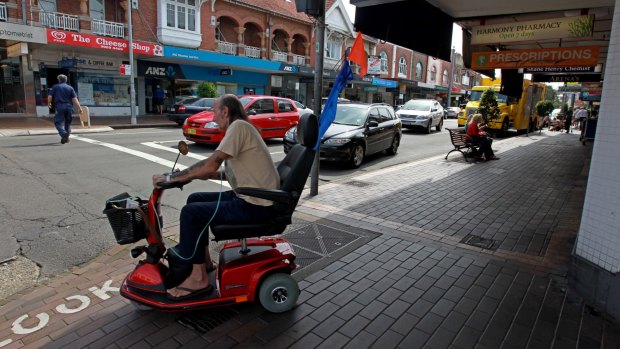 A man rides an electric mobility scooter in Sydney.