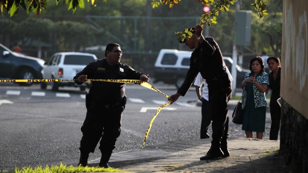 Police secure a crime scene after a bus driver was killed by suspected gang members  on Monday. 