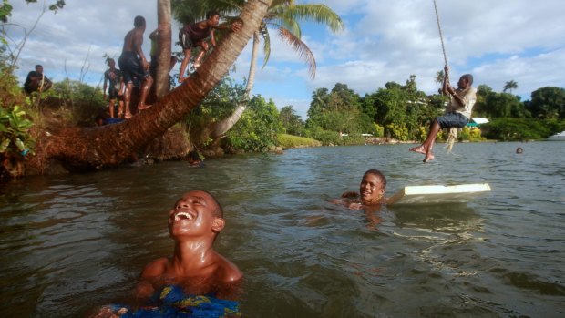 Children play in the water at Lami Bay, near Fiji's capital Suva.