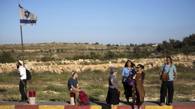 Legal bubble: Israeli citizens stand on a roadside near the settlement of Efrat, near Bethlehem in the Israeli-occupied West Bank.