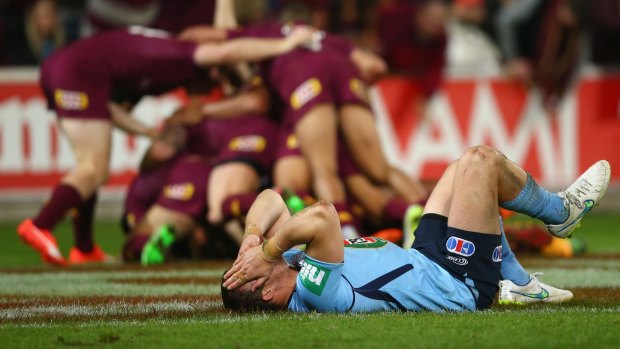 Dismal: Josh Morris slumps to the ground as Queensland cross for yet another try in the Origin decider.