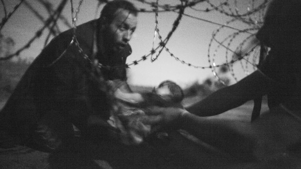 <em>Hope for a new Life</em>, taken by Australian photographer Warren Richardson, has won The World Press Photo of the Year award. The picture shows a man passing a baby through a fence at the Serbia-Hungary border in Roszke, Hungary, on August 28, 2015.