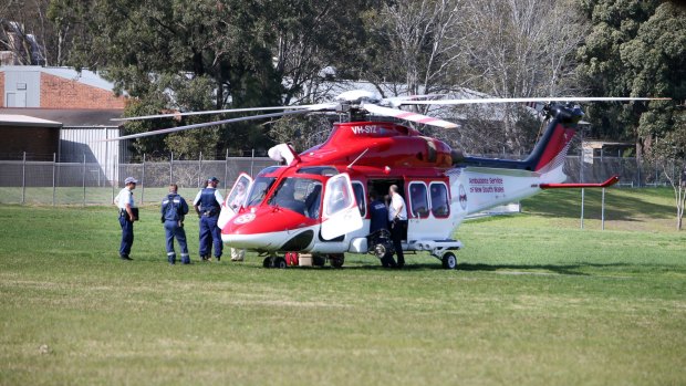 The boy is loaded into an Ambulance helicopter on the school oval.