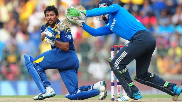 Match-winning display: Sri Lankan Tillekeratne Dilshan is watched by England wicketkeeper Jos Buttler as he plays a shot during the seventh ODI at the R. Premadasa Stadium in Colombo.