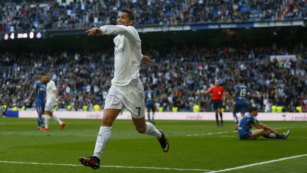 That's the way he likes it: Cristiano Ronaldo celebrates scoring Real Madrid's fourth goal against Getafe.