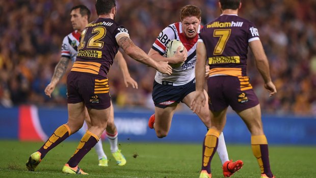 Rooster on the run: Dylan Napa takes on the Broncos' defence at Suncorp Stadium.
