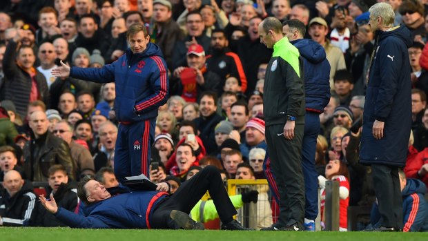 Free-fall: Manchester United and coach Louis van Gaal are  falling fast down the ladder.