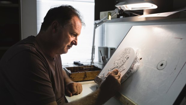 Royal Australian Mint sculptor and coin designer Stevan Stojanovic works on a final plaster positive for the mint's 2018 Year of the Dog collection. 