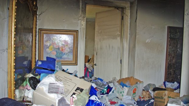 Hoarding in a high-rise unit in Melbourne's south eastern suburbs. The owner was an elderly person who used a mobility aid to climb over a thick layer of rubbish, paper, clothing, boxes and bags.