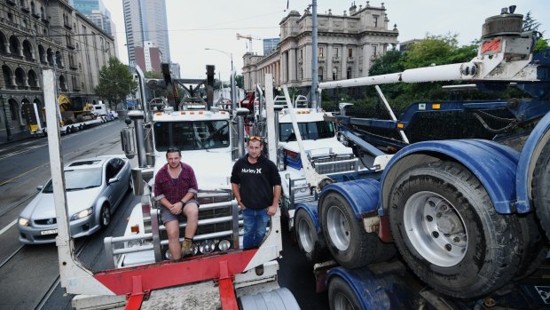 Log trucks parked around State Parliament to protest the closure of the Heyfield Timber Mill.