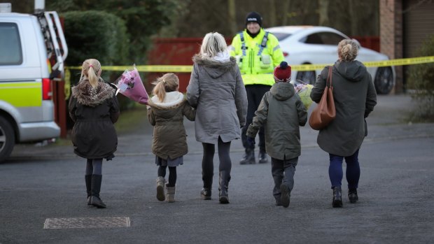 Young children arrive to leave floral tributes near the scene where seven-year-old Katie Rough was murdered. 
