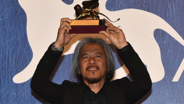 Filipino film maker Lav Diaz holds the Golden Lion award for his movie Ang Babaeng Humayo (The Woman Who Left) during the awards ceremony of the 73rd Venice International Film Festival.