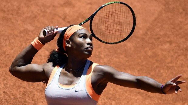 American Serena Williams serves against Spain's Carla Suarez Navarro at the Madrid Open.