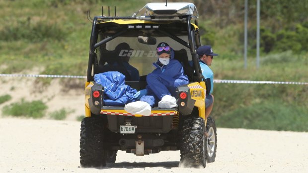 Police Forensic Services transport the remains of the infant off the beach on Sunday.