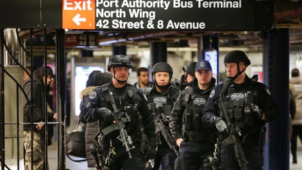 Police officers patrol the Port Authority bus terminal following the explosion.