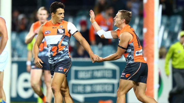 Dylan Shiel of the Giants is congratulated after scoring a goal against the Suns.