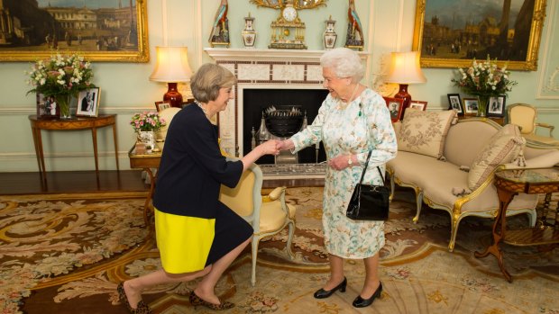 Queen Elizabeth II welcomes Theresa May to Buckingham Palace on Wednesday.