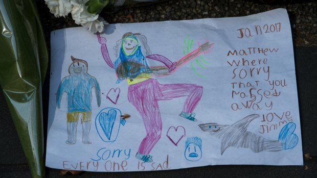 A child's drawing among the tributes left for victims outside the RACV Club on Bourke Street.