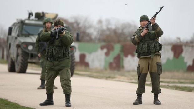 Troops under Russian command fire weapons into the air at the Belbek airbase in Crimea after Russian troops occupied it in March 2014.