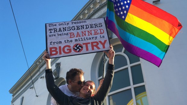 Protesters in San Francisco hold a sign against a proposed ban of transgendered people in the military.
