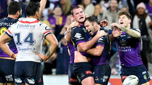Storm's Joe Stimson is hugged by captain Cameron Smith after his match-winning try against the Roosters.