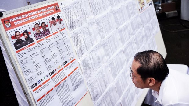 A Jakartan checks for his name at a polling station in the capital. Over 7 million voters are eligible.