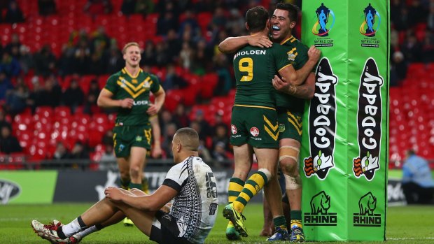 League at Wembley: Andew Fifita and Cameron Smith celebrate a try for Australia against Fiji during the Rugby League World Cup semi-final at Wembley Stadium in 2013.