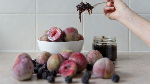 Bowl of plums and plum and onion chutney.
