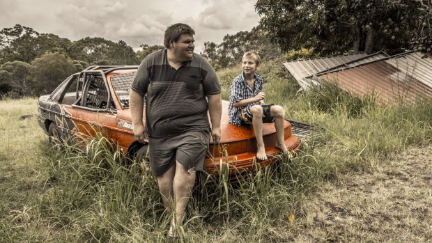 Ride on: Colin with his nephew Hayden, 12. Colin hopes to lose weight and take his nephews and nieces to the Gold Coast theme parks.