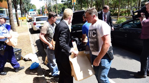 Police take evidence from an upmarket apartment at Sydney's Olympic Park on Tuesday.
