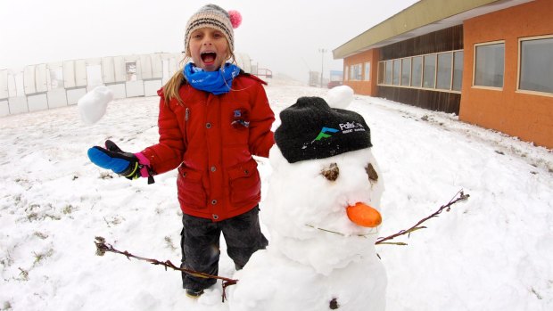 Jacinta Jansen, aged seven, with her first snowman for the year at Falls Creek.