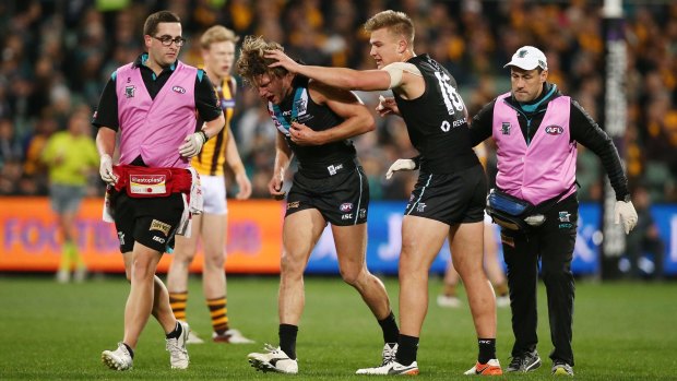 Port Adelaide's Brad Ebert comes from the ground after being injured.
