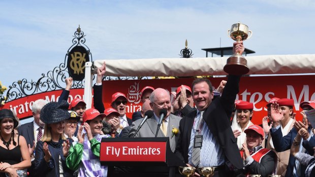 That winning feeling: Connections of Prince Of Penzance celebrate with the Melbourne Cup trophy.