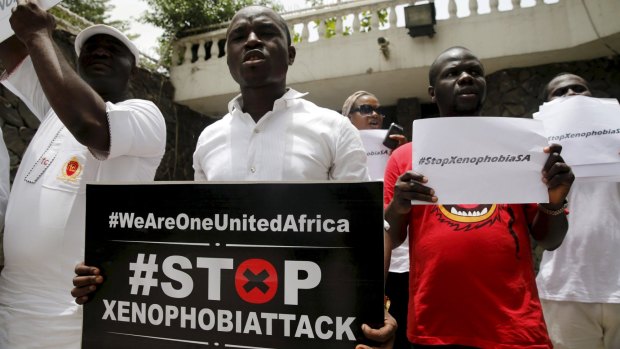 People protesting against xenophobia in South Africa hold placards in front of the South African consulate in Lagos, Nigeria earlier this month.