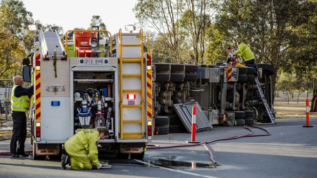 Emergency service crews work at the scene of a truck crash on Drakeford Drive.