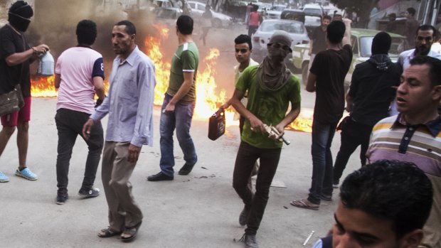 Supporters of the Muslim Brotherhood block a street during clashes with Egyptian forces in Cairo.