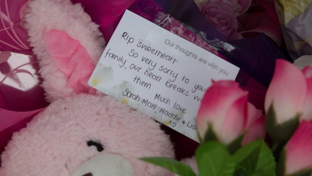 Tributes are left where the body of 15-month-old Sanaya Sahib was found in nearby Darebin Creek.