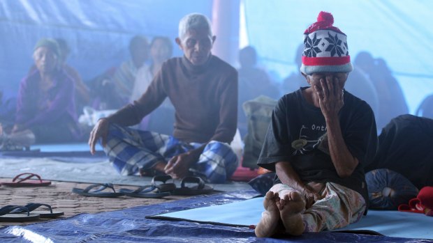 Villagers sit in a temporary shelter in Bali.