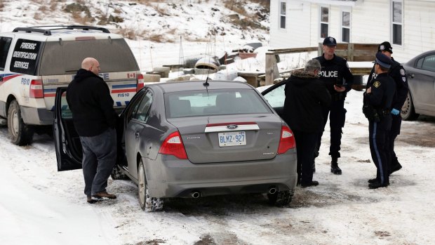 Forensic officers stand outside a house connected to Bruce McArthur in Madoc, Ontario.