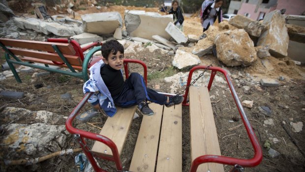 A Palestinian boy sits in the ruins of a children's garden after it was demolished by Israeli troops in the village of Zaatara near the occupied West Bank city of Nablus in April. 