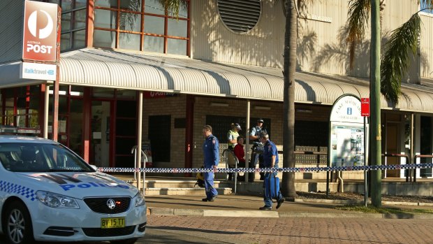 Police at the scene of the shooting outside Warners Bay post office.