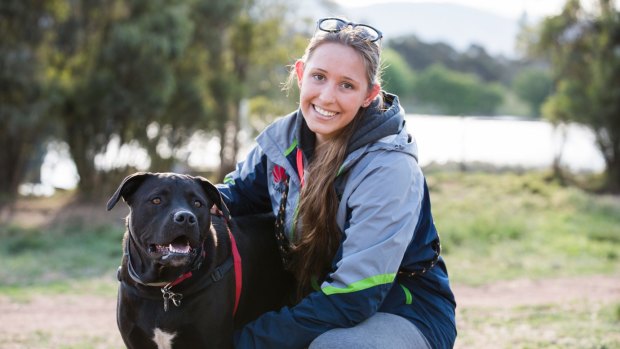 Jana Teivonen, with Oscar the staffy cross lab at the Tuggeranong dog park, disagrees with annual registration for animals.
