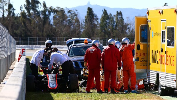 Fernando Alonso receives treatment after the crash.