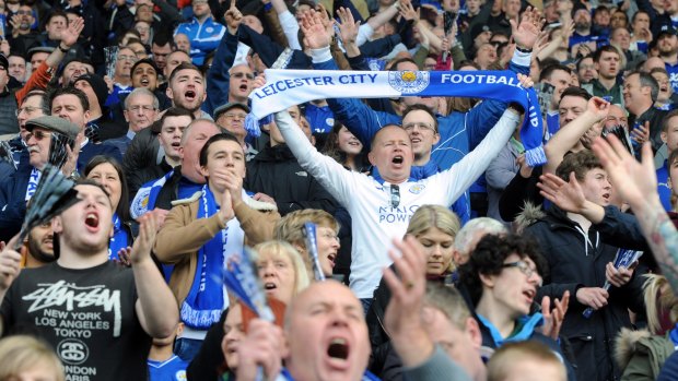 Leicester fans celebrate during the English Premier League soccer match between Leicester City and Southampton at the King Power Stadium in Leicester on April 3, 2016.
