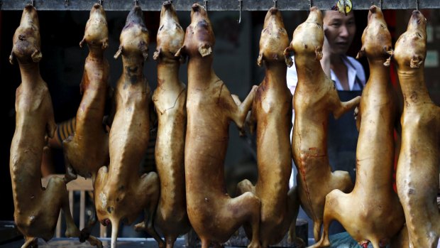 Butchered dogs are displayed at a vendor's stall at the market ahead of a local dog meat festival in Yulin.