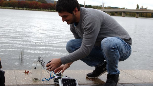 University of Canberra student and research assistant Lorenzo Bertolelli sets up the IoT listening device with a captive frog.